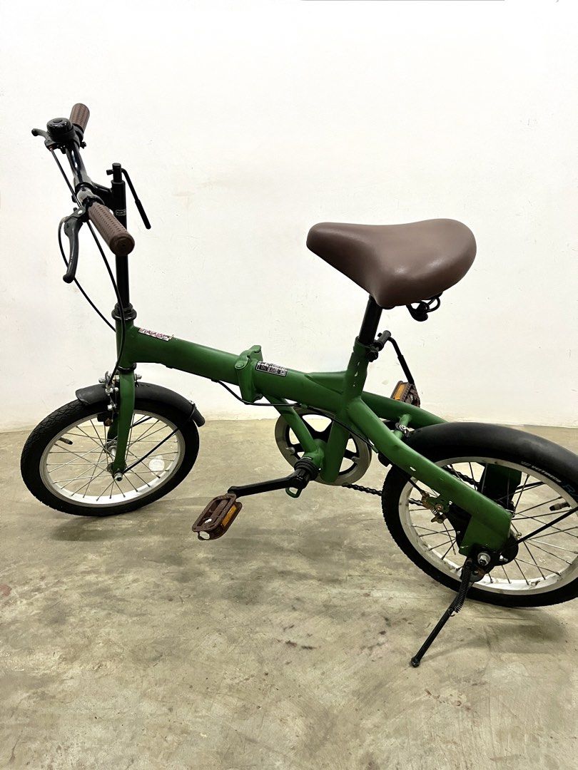 Green Folding Bicycle with Brown Saddle and Handle Grips (Category: Bicycles) located in Santa Rosa. Submitted by annie_annie83 (Listing ID 1446215488, Image 3). Description: - Green folding bike - Comfortable brown saddle and matching grips - Fenders on both wheels for protection - Easy to fold and store, ideal for small spaces - Great for daily commutes or leisurely rides - Well-maintained and ready for a new owner.