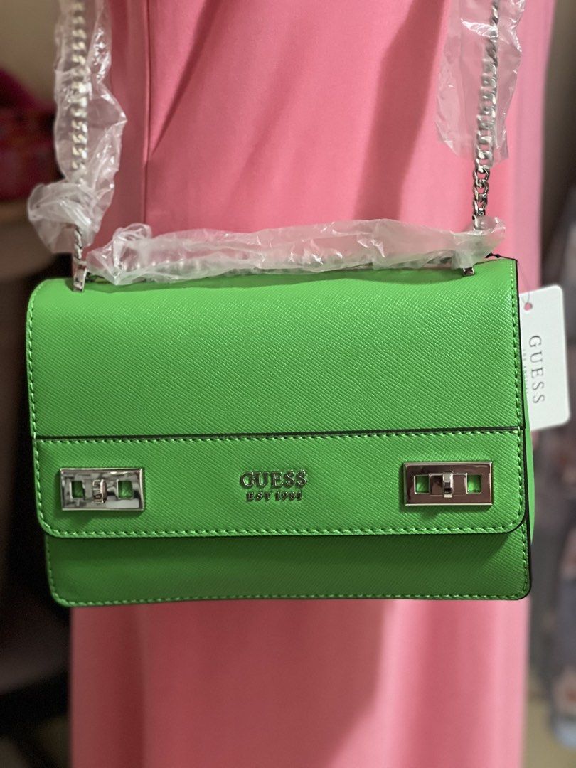 Green Guess crossbody bag with chain strap (Category: Cross-body Bags) located in Lapu Lapu. Submitted by Tinay (Listing ID 1446212345, Image 3). Description: - Adorable green Guess bag - Stylish silver chain strap - Front silver clasp details and Guess logo - Convenient back zip pocket - Includes original tags - Ideal for going out or special occasions item already the lower price COP shipping.