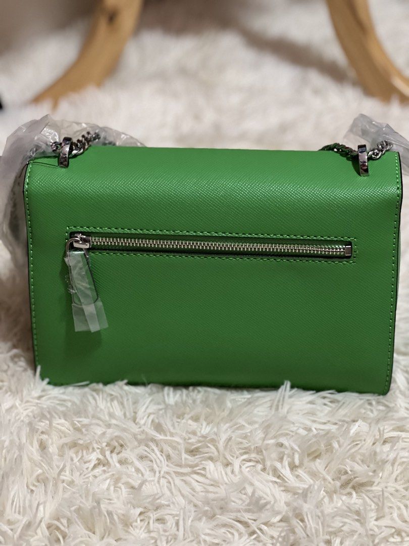 Green Guess crossbody bag with chain strap (Category: Cross-body Bags) located in Lapu Lapu. Submitted by Tinay (Listing ID 1446212345, Image 2). Description: - Adorable green Guess bag - Stylish silver chain strap - Front silver clasp details and Guess logo - Convenient back zip pocket - Includes original tags - Ideal for going out or special occasions item already the lower price COP shipping.
