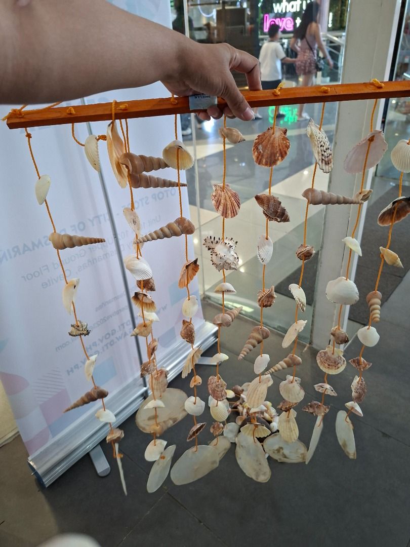 Handmade Shell Wind Chime by Dean (Category: Other Home Decor) located in Caloocan City. Submitted by ednamanlapaz21 (Listing ID 1446315029, Image 3). Description: Beautiful handmade wind chime made with various seashells. Features a wooden bar and orange strings. Perfect for adding a coastal vibe to your home or garden. Each shell is unique. Great for gifting or personal decor. Measures approximately [insert length if known]..