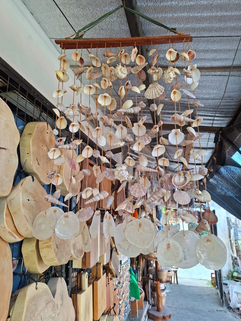 Handmade Shell Wind Chime by Dean (Category: Other Home Decor) located in Caloocan City. Submitted by ednamanlapaz21 (Listing ID 1446315029, Image 2). Description: Beautiful handmade wind chime made with various seashells. Features a wooden bar and orange strings. Perfect for adding a coastal vibe to your home or garden. Each shell is unique. Great for gifting or personal decor. Measures approximately [insert length if known]..