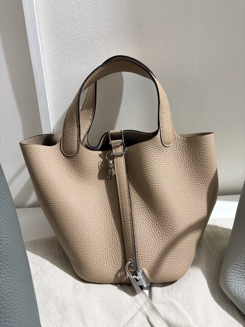 Hermes Picotin Lock Bag - Japan Sourced (Category: Luxury Bags & Wallets) located in Calamba. Submitted by dconsul1023 (Listing ID 1446165109, Image 2). Description: - Authentic Leather with dust bag Available in grey and beige. - Made from premium pebble grain leather. - Includes a secure lock and key. - Handles come with protective wrapping for comfort. - Spacious interior, ideal for everyday essentials..