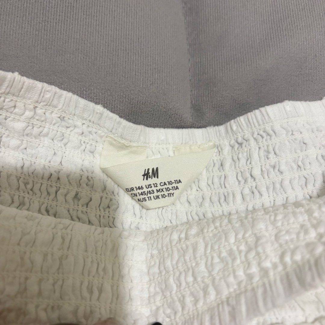 H&M White Ruffled Eyelet Skirt (Category: Skirts) located in Quezon City. Submitted by rivers_ (Listing ID 1446272388, Image 3). Description: White ruffled skirt from H&M • size: xs • smocked waistband • eyelet pattern • used only once .