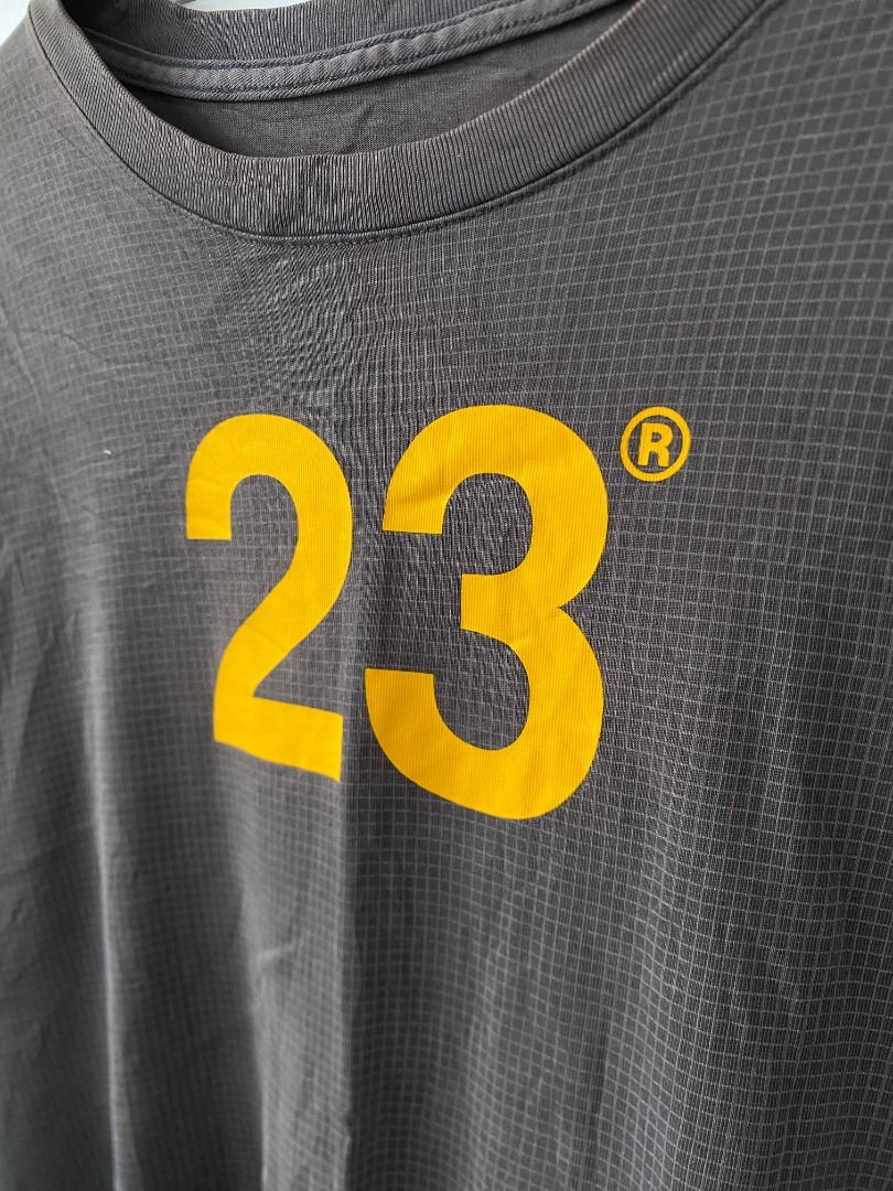 Jordan Engineered For Flight 23 T-Shirt (Category: Tshirts & Polo Shirts ) located in Tagaytay City. Submitted by grayl_thrift (Listing ID 1446314093, Image 3). Description: - Grey Jordan t-shirt - Yellow '23' graphic on front - Jordan logo and 'ENGINEERED FOR FLIGHT SP22' on back - Textured fabric - Loose fit.