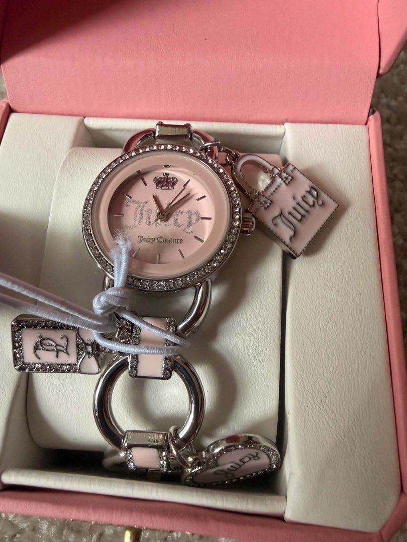 Juicy Couture Pink Watch with Charms (Category: Women's Watches) located in Cagayan de Oro. Submitted by mmmdshop (Listing ID 1446239461, Image 3). Description: - Authentic Juicy Couture watch - Comes with original pink box - Pink watch face with silver accents and crown detail - Rhinestone-encrusted bezel - Charm bracelet style strap - Features a cute handbag charm and a heart charm - A stylish and eye-catching accessory Pre-order available on A