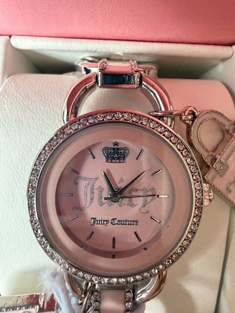 Juicy Couture Pink Watch with Charms (Category: Women's Watches) located in Cagayan de Oro. Submitted by mmmdshop (Listing ID 1446239461, Image 2). Description: - Authentic Juicy Couture watch - Comes with original pink box - Pink watch face with silver accents and crown detail - Rhinestone-encrusted bezel - Charm bracelet style strap - Features a cute handbag charm and a heart charm - A stylish and eye-catching accessory Pre-order available on A