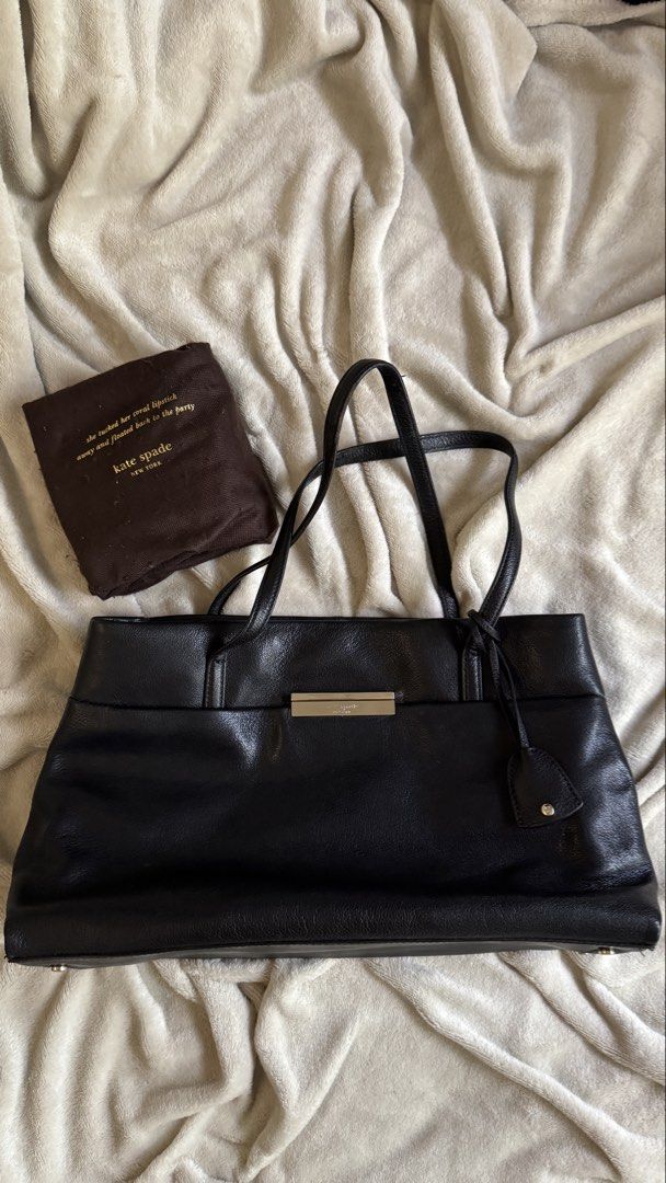 Kate Spade Maiden Way Saffiano Clark Tote Bag (Category: Luxury Bags & Wallets) located in Quezon City. Submitted by raqsinabox (Listing ID 1446199404, Image 2). Description: - Classic black leather tote by Kate Spade - Spacious interior to fit all your essentials - 3 compartments (middle one is zippered) - Sleek metal accent on the front for a touch of elegance - Comes with its original dust bag - Ideal for both work and everyday use - Generous 