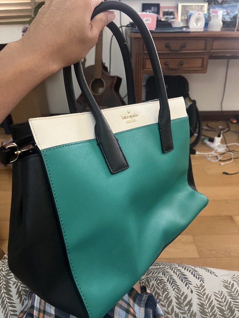 Kate Spade Tote Bag - Teal, White, Black (Category: Tote Bags) located in Cyberjaya. Submitted by ezzfikri1100628 (Listing ID 1446169023, Image 2). Description: - Brand: Kate Spade - Style: Classic Tote Bag - Colors: Teal, White, Black Color Blocking - Features: Top Handles, Striped Interior Lining, Interior Zippered Compartments - Functionality: Spacious, ideal for daily essentials - Versatility: A stylish accessory for any outfit.