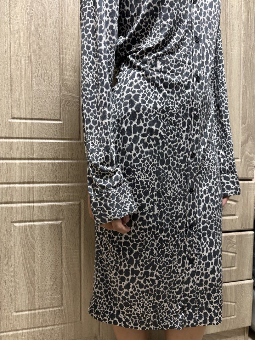 Leopard Print Button-Up Shirt Dress (Category: Dresses) located in Pasay City. Submitted by losient (Listing ID 1446305136, Image 2). Description: - Stylish black and white leopard print long sleeve shirt dress. - Classic collar and button-up front for a timeless look. - Midi length, perfect for dressing up or down. - Comfortable fabric for all-day wear. - A versatile addition to any wardrobe..