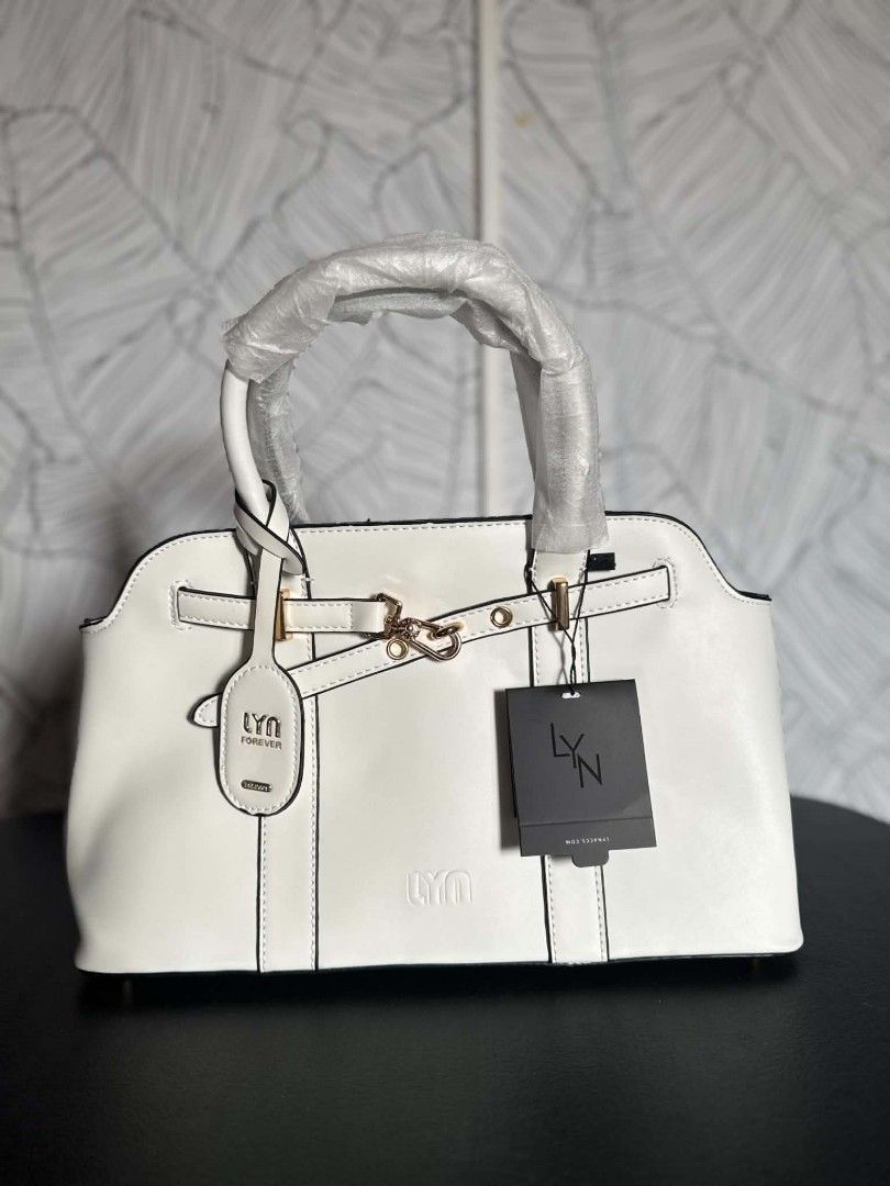 LYN Thailand Bag (Category: Luxury Bags & Wallets) located in Manila. Submitted by vsballeras1984 (Listing ID 1446261964, Image 2). Description: - Pristine white leather handbag - Features a prominent logo tag - Handles still protected with original plastic wrap - Elegant, minimalist design - Versatile for daily use or special events.