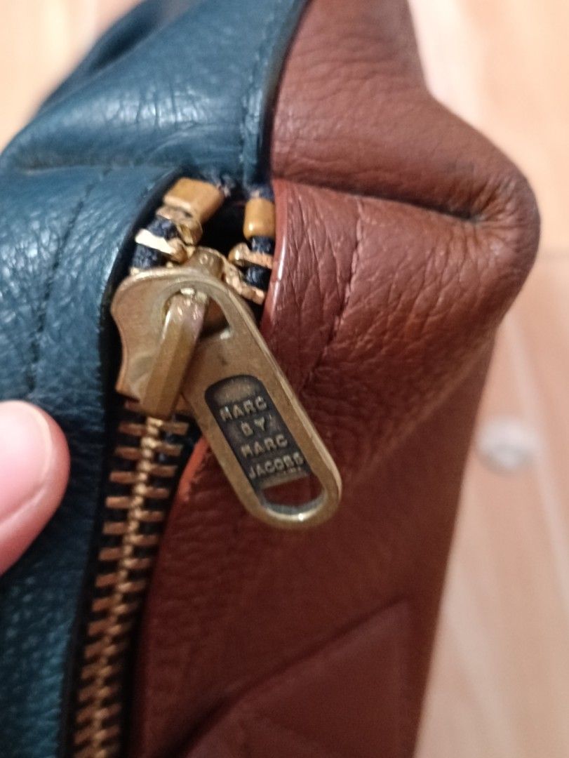 Marc by Marc Jacobs Leather Tote Bag with Strap (Category: Luxury Bags & Wallets) located in Siniloan. Submitted by camellia_19 (Listing ID 1446172636, Image 3). Description: - Chic teal and brown leather tote bag - Front zippered pocket for quick access - Large main compartment for all your essentials - Detachable shoulder strap for versatile carrying - Elegant gold-tone hardware - Authentic Marc by Marc Jacobs branding on zipper pull and interi