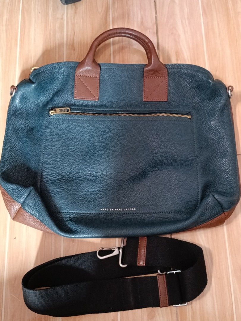 Marc by Marc Jacobs Leather Tote Bag with Strap (Category: Luxury Bags & Wallets) located in Siniloan. Submitted by camellia_19 (Listing ID 1446172636, Image 1). Description: - Chic teal and brown leather tote bag - Front zippered pocket for quick access - Large main compartment for all your essentials - Detachable shoulder strap for versatile carrying - Elegant gold-tone hardware - Authentic Marc by Marc Jacobs branding on zipper pull and interi