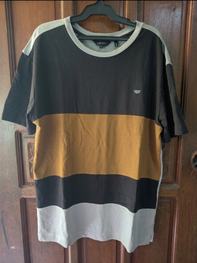 MEMO Color Block T-shirt Size M (Category: Tshirts & Polo Shirts ) located in Manila. Submitted by john16bit (Listing ID 1446211883, Image 1). Description: - Size: Medium (M), W19.5 x L26 - Color Block Design: Black, Tan, Grey - Small MEMO logo on chest - Material: 100% Cotton - Perfect for casual wear RFS: Declutter, I don't wear it anymore.