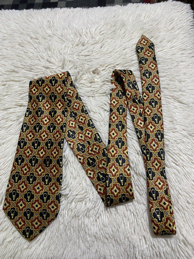 Mercedes Hand Made Silk Tie (Category: Ties) located in Bulacan. Submitted by rich2545 (Listing ID 1446168638, Image 1). Description: - Handmade Mercedes tie - Made of 100% Silk - Features a unique geometric pattern with lightbulb motifs - Colors: Black, Red, and Gold - Versatile: Great for both formal and casual occasions - Adds a stylish pop of color to any ensemble.