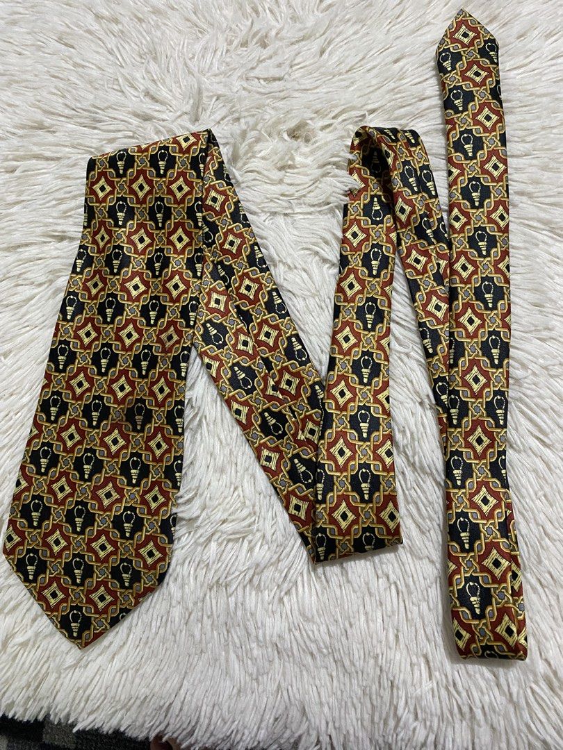 Mercedes Hand Made Silk Tie (Category: Ties) located in Bulacan. Submitted by rich2545 (Listing ID 1446168638, Image 2). Description: - Handmade Mercedes tie - Made of 100% Silk - Features a unique geometric pattern with lightbulb motifs - Colors: Black, Red, and Gold - Versatile: Great for both formal and casual occasions - Adds a stylish pop of color to any ensemble.