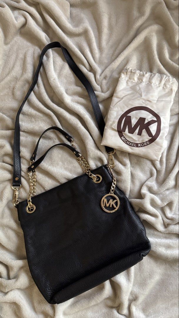 Michael Kors Black Pebbled Leather Shoulder Bag (Category: Luxury Bags & Wallets) located in Quezon City. Submitted by raqsinabox (Listing ID 1446198536, Image 3). Description: - Authentic Michael Kors shoulder bag - Classic black leather - Elegant gold hardware chain detailing - Gold-tone chain handles and signature round MK medallion charm - Includes original dust bag - Dimensions: Approx. 12" wide x 10" tall - Ideal for everyday wear.