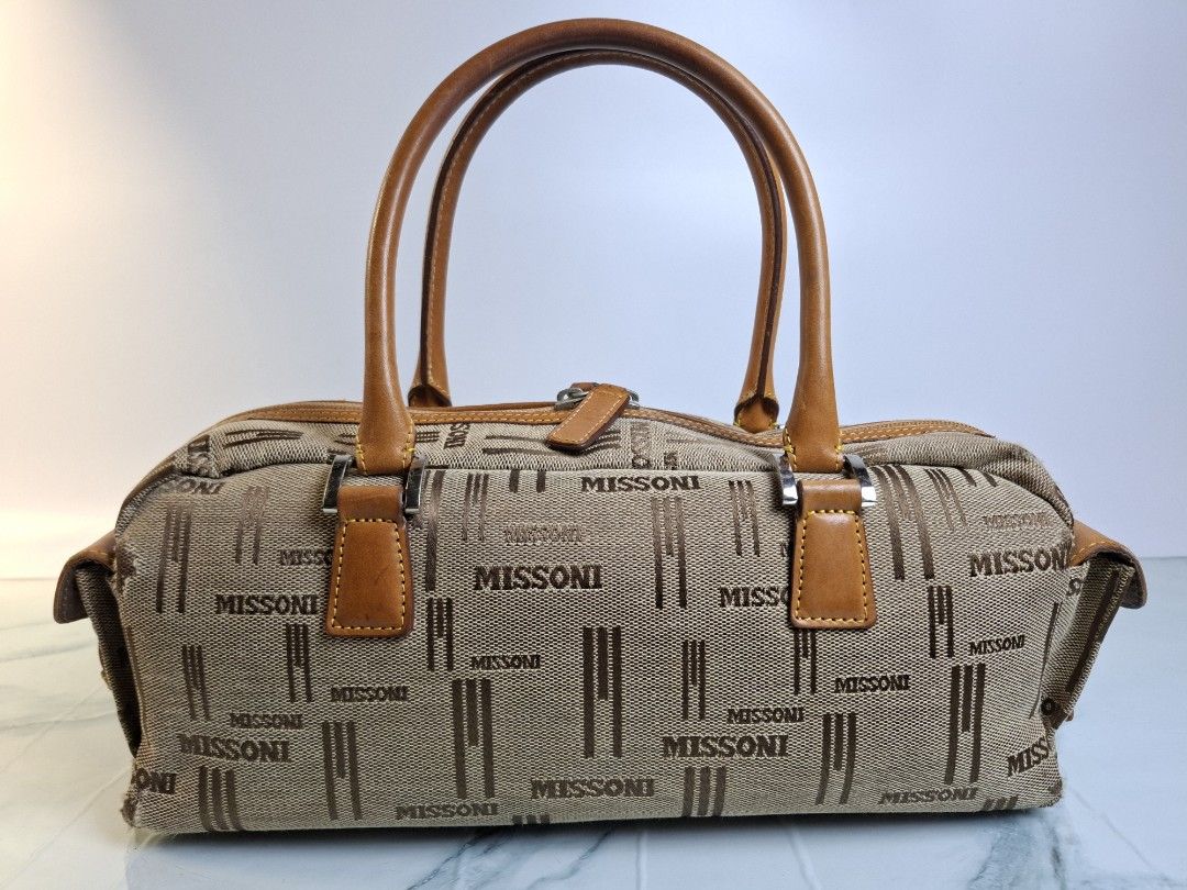 Missoni Monogram Canvas Leather Trimmed Boston Bag (Category: Luxury Bags & Wallets) located in Pasay City. Submitted by onick_79 (Listing ID 1446339136, Image 2). Description: Elegant vintage Missoni handbag featuring the iconic monogram canvas with genuine tan leather trim and rolled handles. A timeless Italian piece perfect for everyday wear. 👜 Details • Size: 32 × 11 × 12 cm • Handle Drop: 13 cm • Monogram canvas with genuine leather trim • 