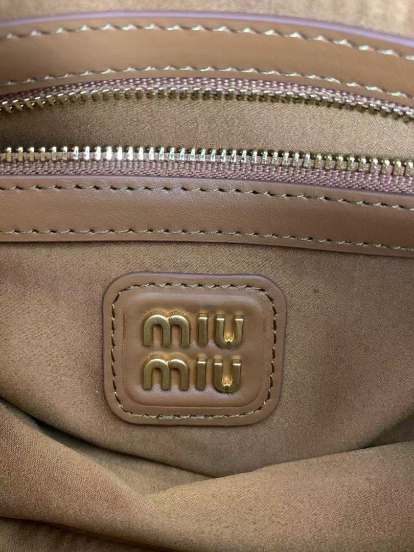 Miu Miu Brown Leather Top Handle Bag (Category: Luxury Bags & Wallets) located in Quezon City. Submitted by berinavuth82129 (Listing ID 1446238819, Image 2). Description: - Genuine brown leather Miu Miu bag - Features iconic Miu Miu logo embossed on the front - Equipped with comfortable top handles - Elegant gold hardware accents - Classic, versatile shape ideal for daily wear - Adds a chic and stylish touch to any outfit.