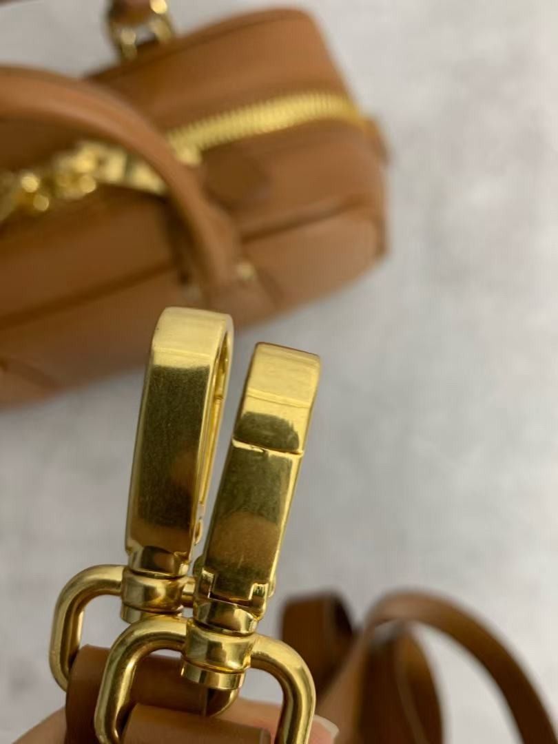 Miu Miu Brown Leather Top Handle Bag (Category: Luxury Bags & Wallets) located in Quezon City. Submitted by berinavuth82129 (Listing ID 1446238819, Image 3). Description: - Genuine brown leather Miu Miu bag - Features iconic Miu Miu logo embossed on the front - Equipped with comfortable top handles - Elegant gold hardware accents - Classic, versatile shape ideal for daily wear - Adds a chic and stylish touch to any outfit.