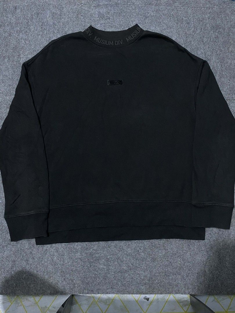 MUSIUM DIV. Black Crewneck Sweatshirt (Category: Coats, Jackets and Outerwear) located in Caloocan City. Submitted by nashper (Listing ID 1446329918, Image 1). Description: - Brand: MUSIUM DIV. - Type: Black Crewneck Sweatshirt - Size: 34 - Details: "MUSIUM DIV." text around collar, small logo tag on chest - Back Detail: "ADDICT-INSANE" embroidery - Occasion: Casual wear.
