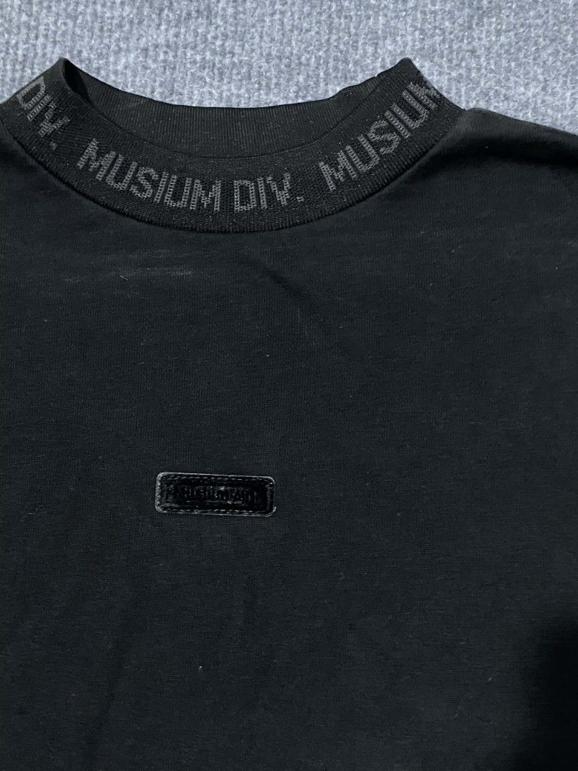 MUSIUM DIV. Black Crewneck Sweatshirt (Category: Coats, Jackets and Outerwear) located in Caloocan City. Submitted by nashper (Listing ID 1446329918, Image 2). Description: - Brand: MUSIUM DIV. - Type: Black Crewneck Sweatshirt - Size: 34 - Details: "MUSIUM DIV." text around collar, small logo tag on chest - Back Detail: "ADDICT-INSANE" embroidery - Occasion: Casual wear.