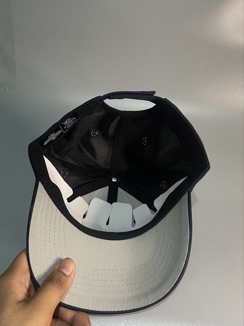 Navy Blue Baseball Cap with Embroidered Dog Logo (Category: Caps & Hats) located in Manila. Submitted by gilmorecapz (Listing ID 1446277408, Image 2). Description: - Navy blue baseball cap - Features a yellow embroidered dog logo with a baseball bat - Adjustable strap at the back for a custom fit - Ideal for casual wear or sports activities.