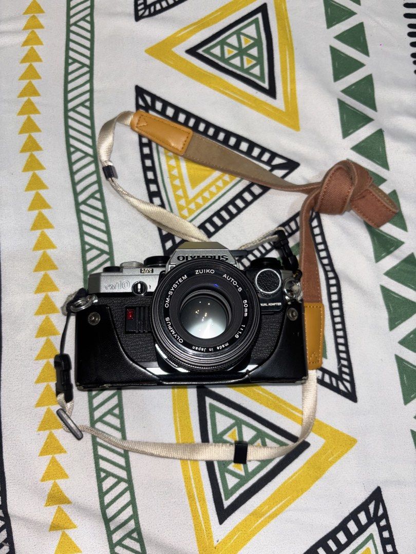 Olympus OM10 (Film Camera) (Category: Cameras) located in Muntinlupa City. Submitted by repriegerator (Listing ID 1446341450, Image 2). Description: condition: - all features fully functional including self timer - stored in a dry box lens: - comes with Zuiko auto-s 50mm 1:1,8 lens inclusions: - battery - original leather case and strap Sample Pics attached on this post (buyer to shoulder shipping) .