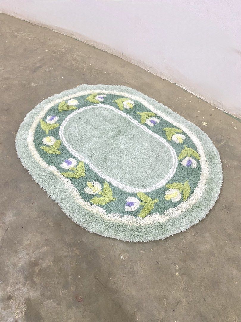 Oval Tufted Bath Mat with Floral Border (Category: Carpets, Mats & Flooring) located in Santa Rosa. Submitted by annie_annie83 (Listing ID 1446217129, Image 3). Description: - Cute oval bath mat - Light green color - Embroidered flowers (white, purple, green leaves) - Fuzzy texture - Adds a nice touch to your bathroom.