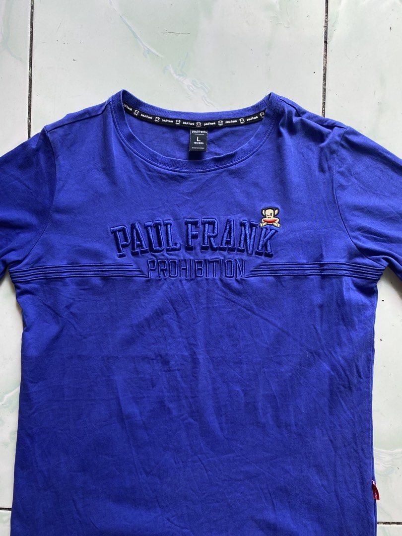 Paul Frank Julius Monkey Embroidered Graphic Tee Blue (Category: Tshirts & Polo Shirts ) located in Nagcarlan. Submitted by puredriponly (Listing ID 1446200855, Image 2). Description: 💙 ✔️ Original Paul Frank design ✔️ Embroidered “PAUL FRANK PROHIBITION” logo sa harap ✔️ May iconic Julius monkey patch detail ✔️ Soft at komportableng tela ✔️ Perfect para sa casual at streetwear outfit ✔️ Color: Blue ✔️ Size: L (check actual measurements para sur