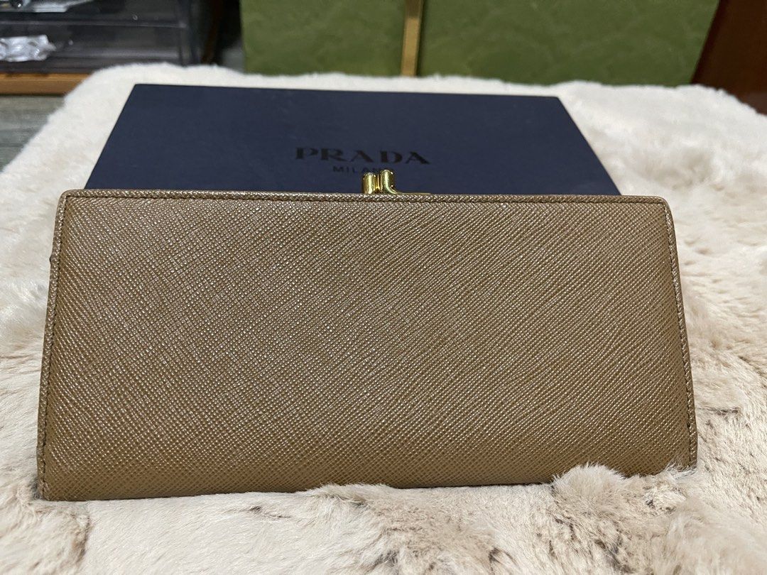 Prada Saffiano Leather Wallet (Category: Luxury Bags & Wallets) located in Cavite. Submitted by beamitch (Listing ID 1446196445, Image 3). Description: - Authentic brown Prada wallet - Made of durable Saffiano leather - Elegant gold hardware - Secure clasp closure - Comes with original Prada box - Ideal for everyday use - Spacious interior for cards and cash mode of shipping: lbc only or any rider to be book by the buyer.