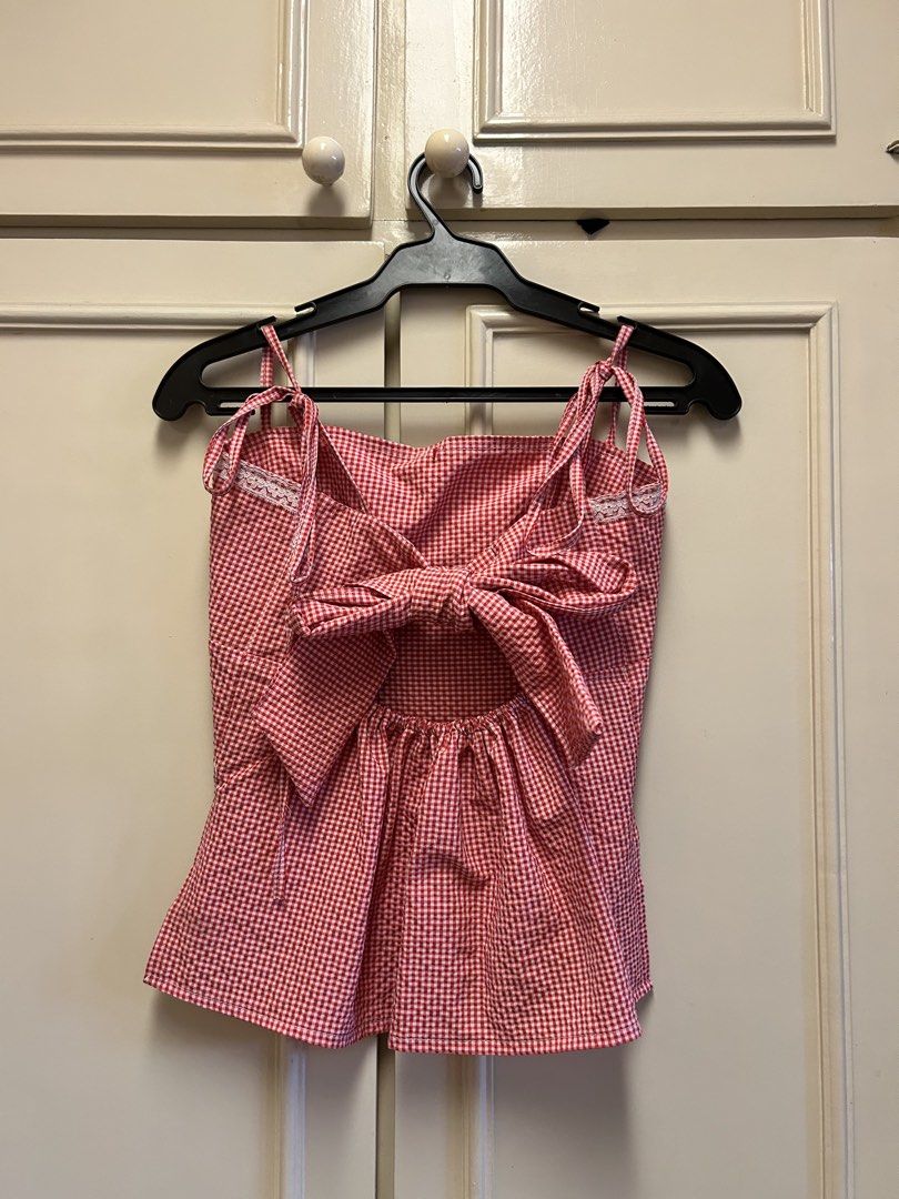 Red Gingham Tie Back Crop Top with Lace Trim (Category: Sleeveless) located in Muntinlupa City. Submitted by caradb (Listing ID 1446243314, Image 2). Description: - Adorable red gingham crop top - Sweetheart neckline with delicate lace trim - Adjustable tie straps for a perfect fit - Chic open back design with a large bow detail - Lightweight fabric, ideal for warm weather - Great for summer days, picnics, or a cute, casual look - Pairs perfectly