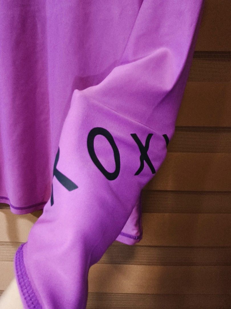 Roxy Purple Long Sleeve Rash Guard Top (Category: Rash guard) located in Baguio. Submitted by zia_zab (Listing ID 1446309041, Image 3). Description: - Purple Roxy long sleeve rash guard - Features Roxy logo on front and sleeve - Made from a comfortable nylon and spandex blend - Ideal for surfing, swimming, or any water activity - Provides a comfortable fit for active days - Refer to label for care instructions -In very good condition -No flaws -C
