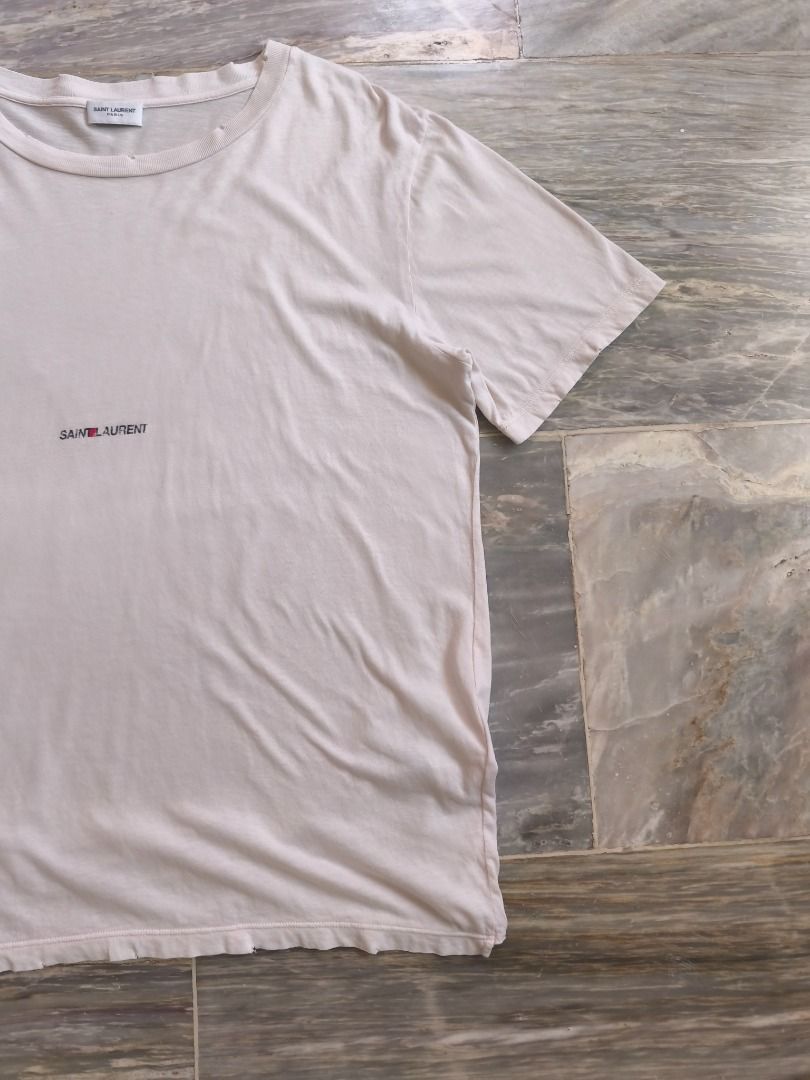 Saint Laurent Paris Tee (Category: Luxury Apparel) located in Lucena. Submitted by 0174.archive (Listing ID 1446167462, Image 3). Description: distressed effect on neck, sleeve & hem very good used condition 9/10 condition rating flaw - crack on print color: off white / cream Actual Measurements (inches) Chest (pit to pit): 21 Length: 27 Shoulder:19 Sleeve: 9 Message before buying if you have question Items are new / pre-loved / second hand used 