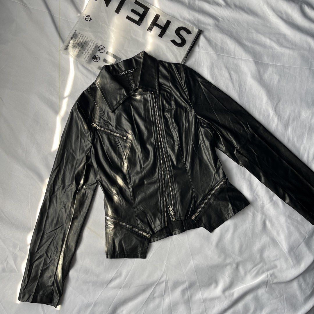 SHEIN Black Faux Leather Biker Jacket (Category: Coats, Jackets and Outerwear) located in Manila. Submitted by marybelle.mb (Listing ID 1446257017, Image 1). Description: - Black faux leather biker jacket from SHEIN - Asymmetrical zip front - Multiple zip pockets - Pointed collar - Long sleeves with zip cuffs - Cropped hemline - Ideal for layering.