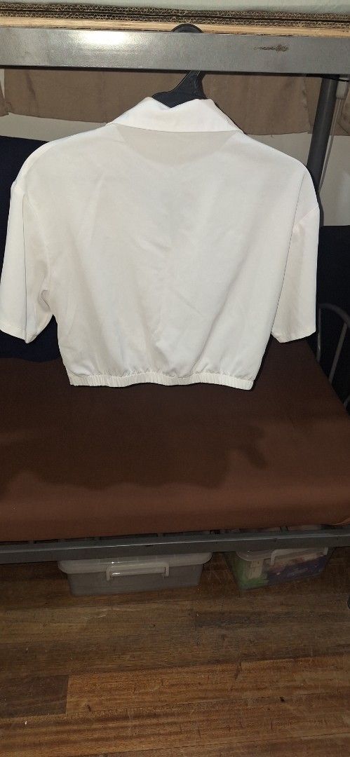 SHEIN White Cropped Twist Front Shirt (Category: Others Tops) located in Manila. Submitted by julie_pc (Listing ID 1446316529, Image 3). Description: Pre Loved SHEIN white cropped shirt, size L (fits like). Features a twist front hem, short sleeves, and collar. Perfect for casual or dressed-up looks..