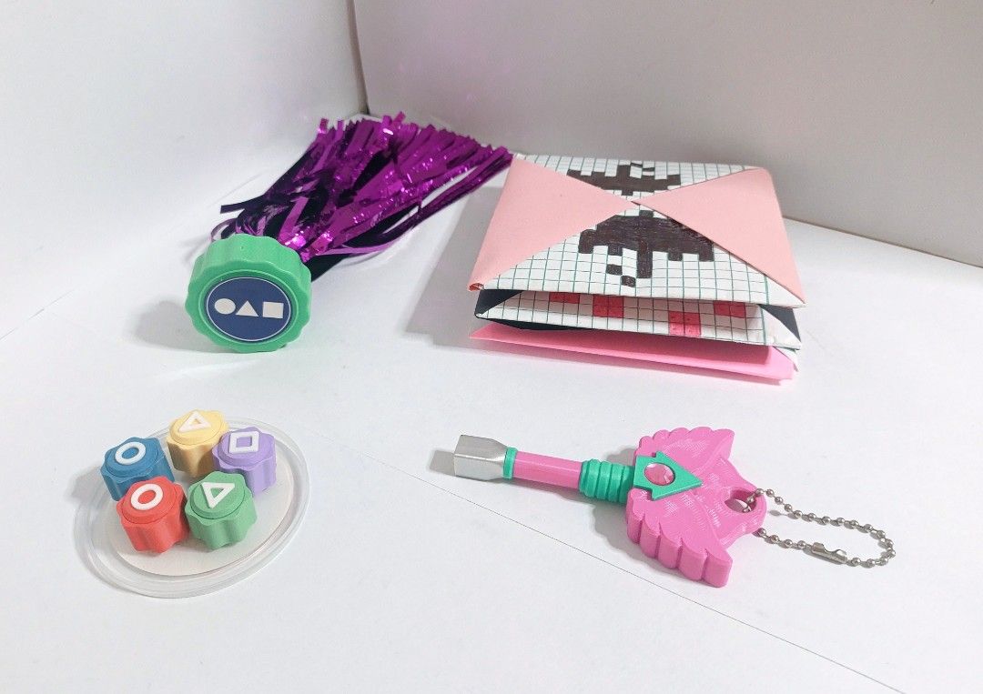 Squid Game Accessories set (Category: Figurines & Statues) located in Manila. Submitted by gcv237. (Listing ID 1446339168, Image 1). Description: Sauid Game Accessories Set! ⏺️🔼⏹️ ☂️🔑 Set includes: 3 Style Custom-made Ddakji (딱지) Condition: 9/10 (minimum creases ) 3D Printed Hide & Seek key Condition: 8/10 (detaching from the base) 3D Printed Gonggi (공기) Condition: 10/10 (Not played with, only stored) Jegichagi (제기차기) Condition: 9.5/10 (Not pla