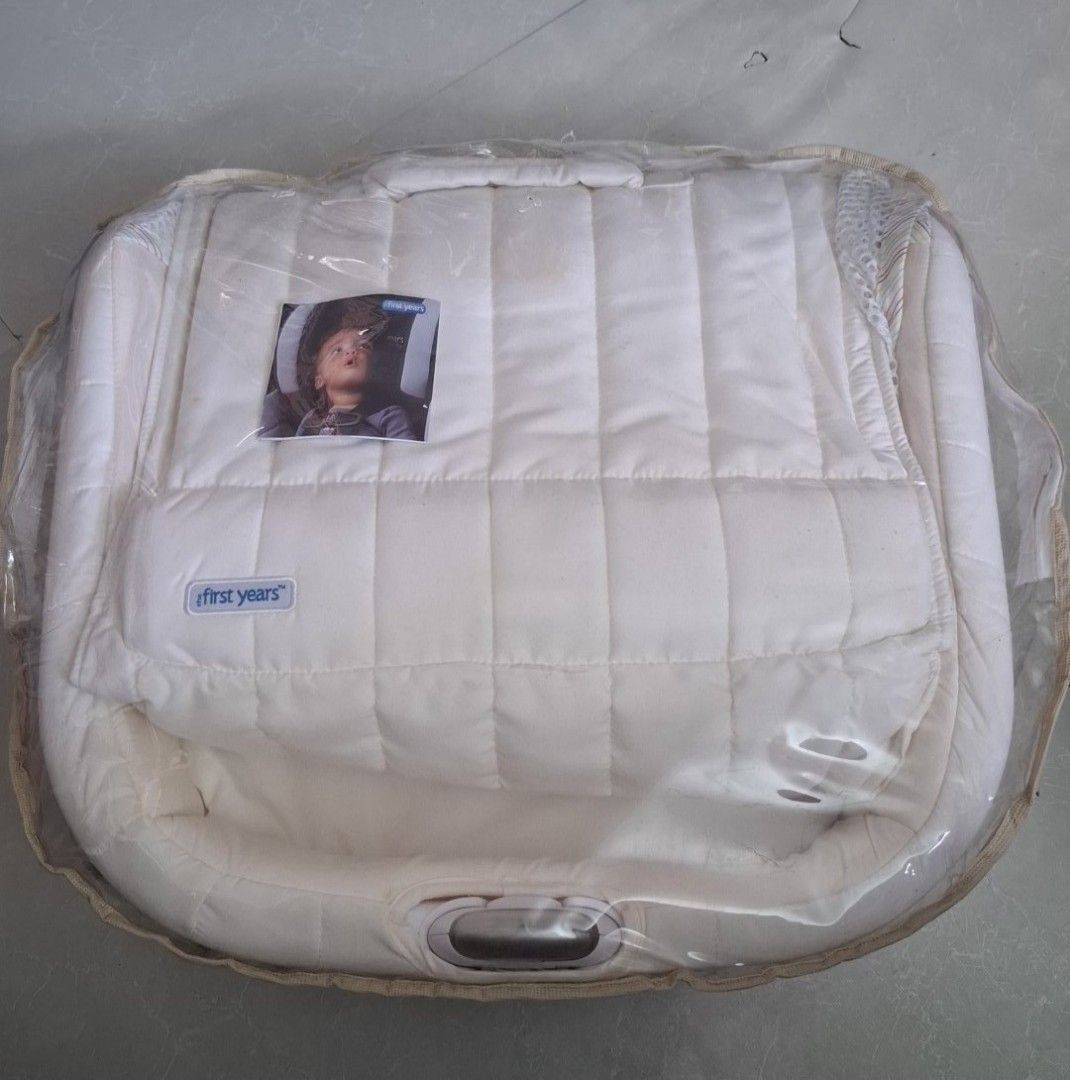 The First Years Baby Car Seat Insert Pad (Category: Car Seats) located in Pasay City. Submitted by al1son18 (Listing ID 1446216718, Image 1). Description: - White quilted insert pad for baby car seats - Includes a clear plastic cover - Features the 'The First Years' brand logo - Comes with a small picture of a baby in a car seat - Designed for your baby's comfort during travel.
