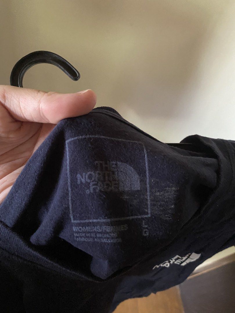 The North Face T-shirt Size L (Category: Tshirts & Polo Shirts ) located in Paranaque City. Submitted by helloooooopoo (Listing ID 1446222895, Image 3). Description: - Brand: The North Face - Color: Navy Blue - Size: Women's L - Design: Classic logo on front left chest, large 'Never Stop Exploring' graphic with logo on back - Origin: Made in El Salvador dm for questions .