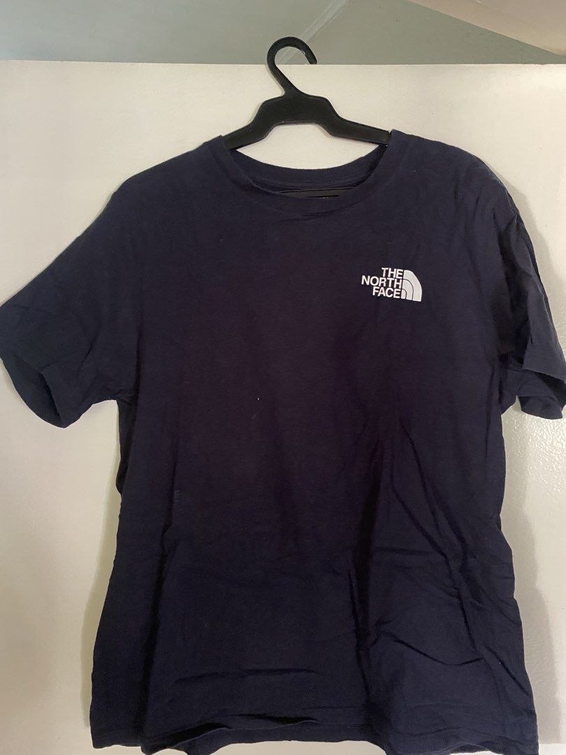 The North Face T-shirt Size L (Category: Tshirts & Polo Shirts ) located in Paranaque City. Submitted by helloooooopoo (Listing ID 1446222895, Image 1). Description: - Brand: The North Face - Color: Navy Blue - Size: Women's L - Design: Classic logo on front left chest, large 'Never Stop Exploring' graphic with logo on back - Origin: Made in El Salvador dm for questions .