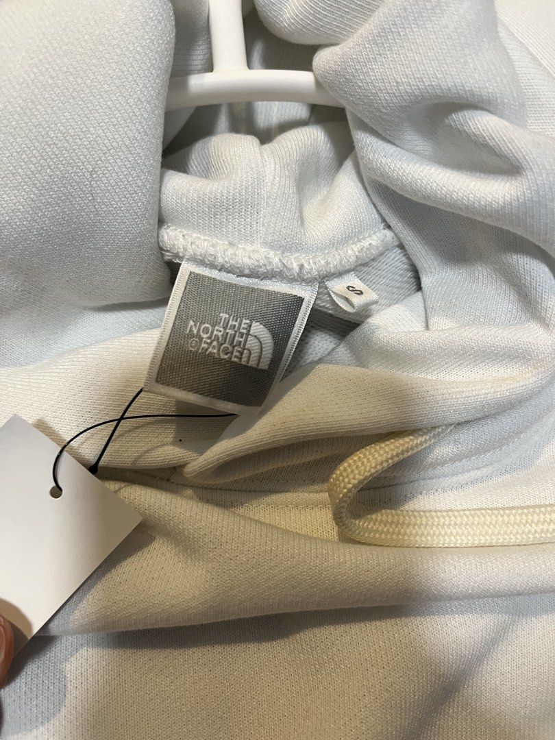 The North Face White Hoodie (Category: Coats, Jackets and Outerwear) located in Quezon City. Submitted by classychicph92 (Listing ID 1446267702, Image 2). Description: - Brand: The North Face - Color: White - Features: Small embroidered logo on chest, drawstring hood, front pocket - Style: Comfortable, classic, great for everyday wear.