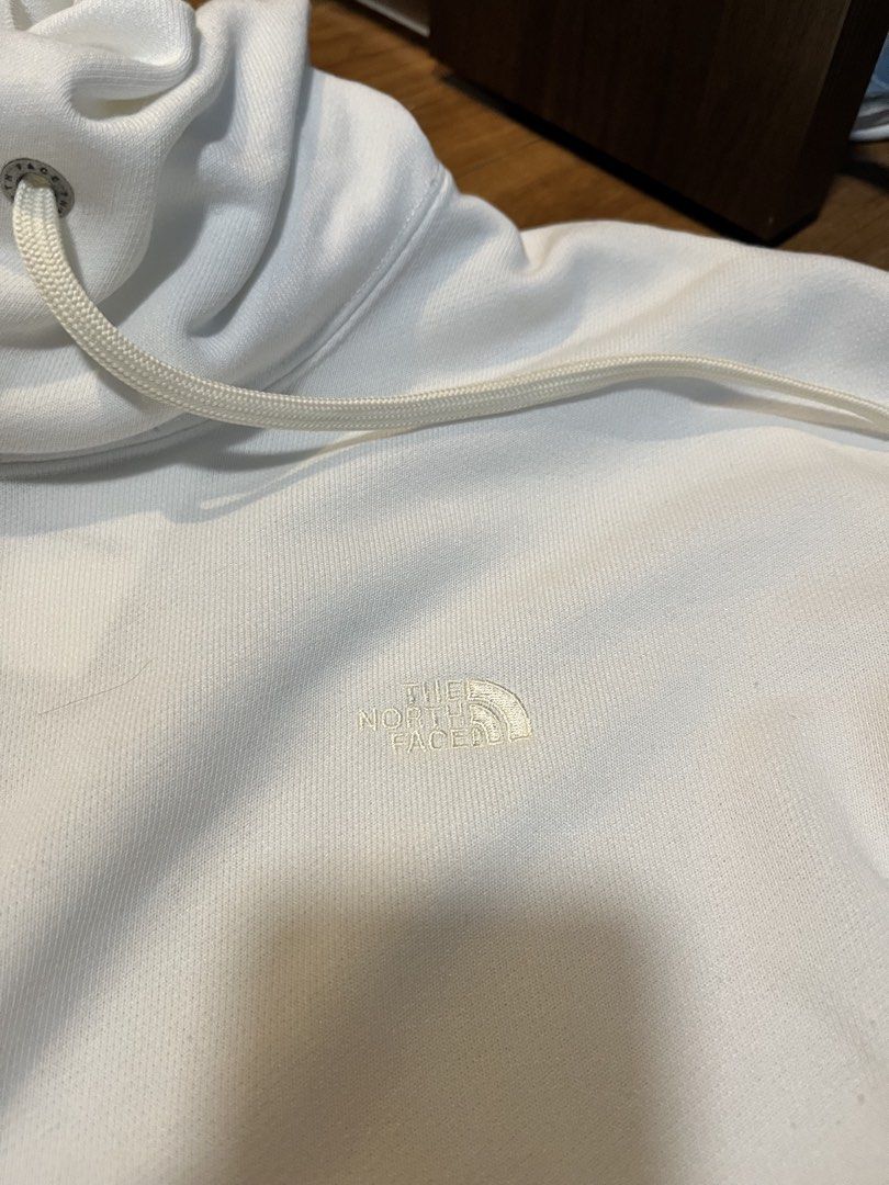 The North Face White Hoodie (Category: Coats, Jackets and Outerwear) located in Quezon City. Submitted by classychicph92 (Listing ID 1446267702, Image 3). Description: - Brand: The North Face - Color: White - Features: Small embroidered logo on chest, drawstring hood, front pocket - Style: Comfortable, classic, great for everyday wear.
