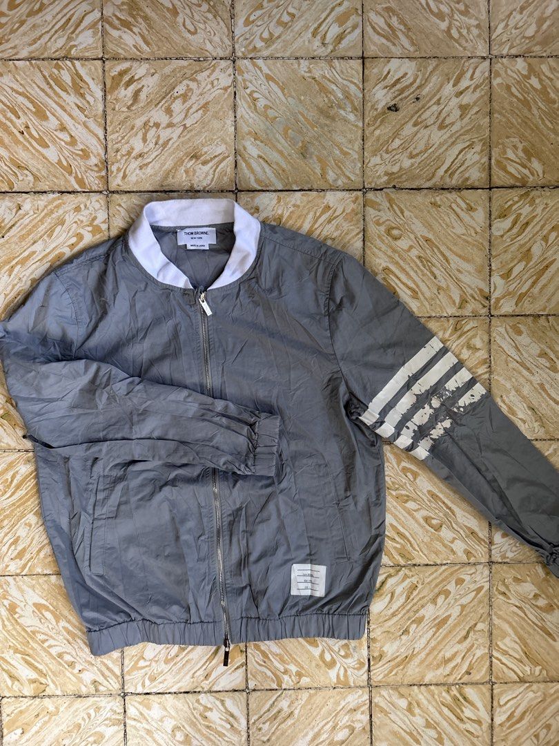 Thom Browne 4 Bar Bomber Jacket Made in Japan (Category: Coats, Jackets and Outerwear) located in Dipolog. Submitted by adrian281994 (Listing ID 1446198600, Image 2). Description: - Authentic Thom Browne Grey Bomber Jacket Size 3 - Signature four-stripe detail on sleeve - Classic white collar and cuffs - Secure zipper closure - Expertly crafted in Japan 🇯🇵 - Versatile and stylish wardrobe essential.
