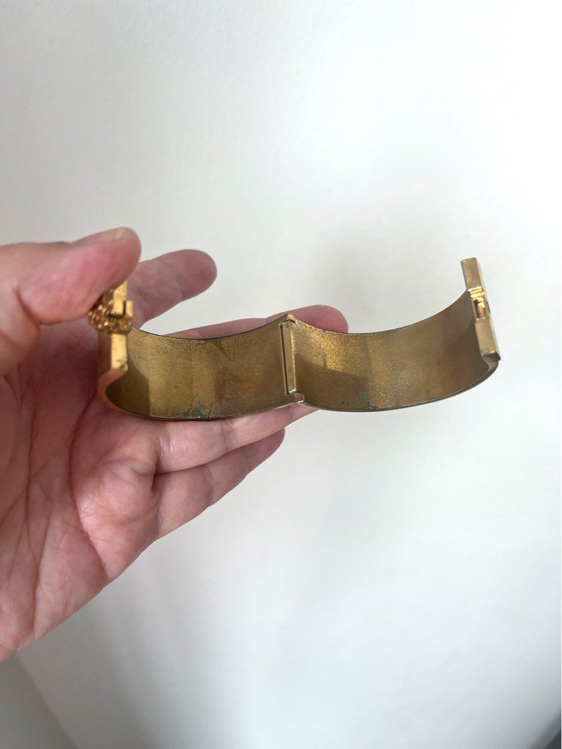 Tory Burch Gold and Tan Leather Logo Bangle (Category: Bracelets) located in Manila. Submitted by r.ruth (Listing ID 1446181578, Image 3). Description: - Authentic Tory Burch bangle - Gold-tone finish - Tan leather detailing - Features iconic Tory Burch logo - Secure hinged closure - Shows signs of wear on the inside metal, consistent with normal use - NOT FOR FUSSY BUYER .
