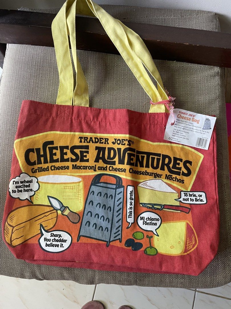 Trader Joe's Cheese Adventures Tote Bag (Category: Tote Bags) located in Pasig City. Submitted by khaleisi (Listing ID 1446227246, Image 1). Description: - Fun 'Cheese Adventures' graphic with cheese puns - Made of heavy-duty 100% cotton - Machine washable (cold) - May shrink slightly - Printed on recycled paper - Ideal for groceries and everyday use.