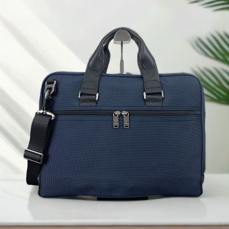 Tumi Alpha Bravo Academy Compact Laptop Bag (Category: Briefcases) located in Manila. Submitted by bagmaniaph (Listing ID 1446211176, Image 3). Description: - Navy blue Tumi briefcase - Made with durable nylon and leather accents - Features a detachable shoulder strap - Ample interior space for work essentials - Smooth-gliding zippers - Clean exterior and interior condition - Ideal for daily commutes and business trips.