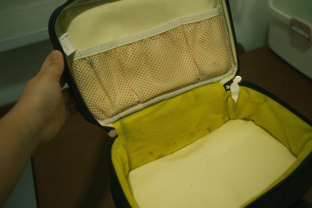 V-Cool Black Insulated Cooler Bag (Category: Breastfeeding & Bottle Feeding) located in San Fernando. Submitted by attg_ (Listing ID 1446186805, Image 3). Description: - Black V-Cool cooler bag - Features a top handle for easy carrying - Front zippered pocket for extra storage - Interior mesh pocket section - Note: Some marks inside the main compartment - Zippers are in good working condition.