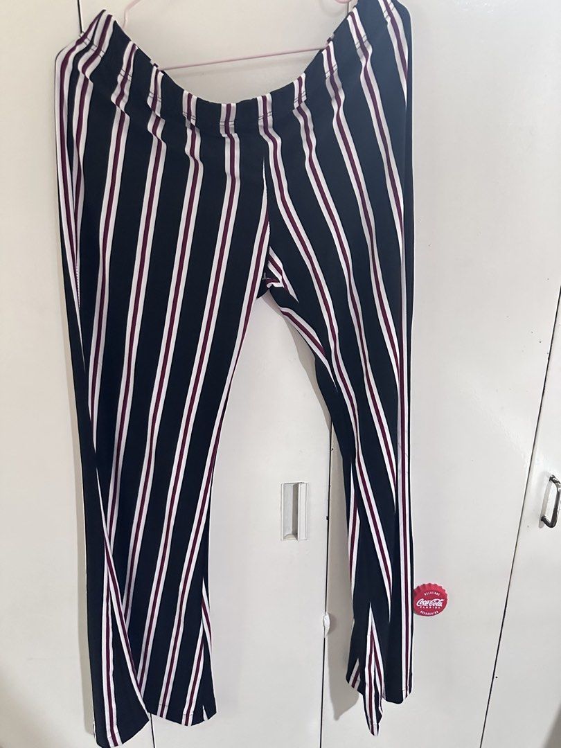 Vibe Sportswear Striped Pants (Category: Other Bottoms) located in Pasig City. Submitted by kyle.closet (Listing ID 1446243528, Image 1). Description: - Stylish black pants with white and maroon stripes. - Flattering high-waisted design with a comfortable elastic waistband. - Trendy wide-leg silhouette with a chic slit at the hem. - Versatile for casual outings or dressing up. - Effortlessly pairs with various tops for a complete look..