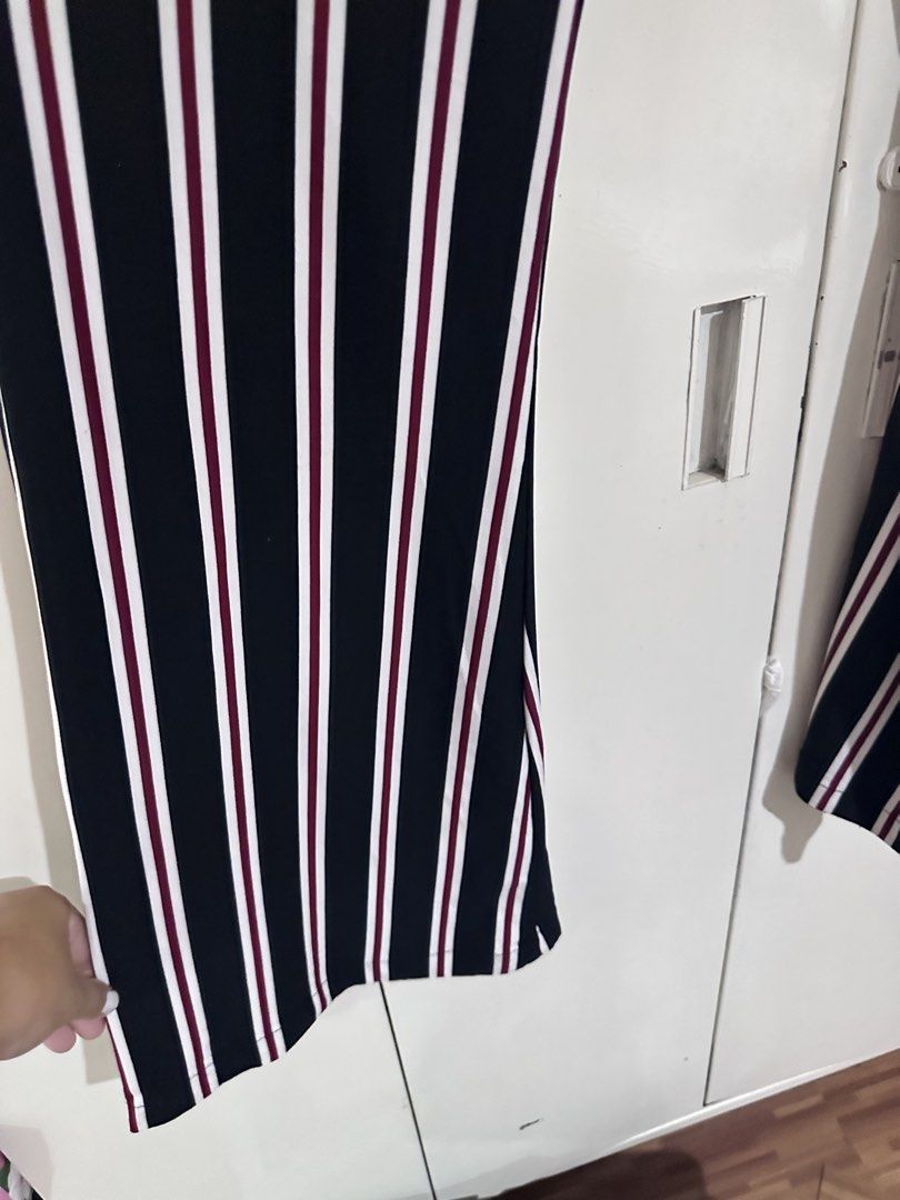 Vibe Sportswear Striped Pants (Category: Other Bottoms) located in Pasig City. Submitted by kyle.closet (Listing ID 1446243528, Image 3). Description: - Stylish black pants with white and maroon stripes. - Flattering high-waisted design with a comfortable elastic waistband. - Trendy wide-leg silhouette with a chic slit at the hem. - Versatile for casual outings or dressing up. - Effortlessly pairs with various tops for a complete look..