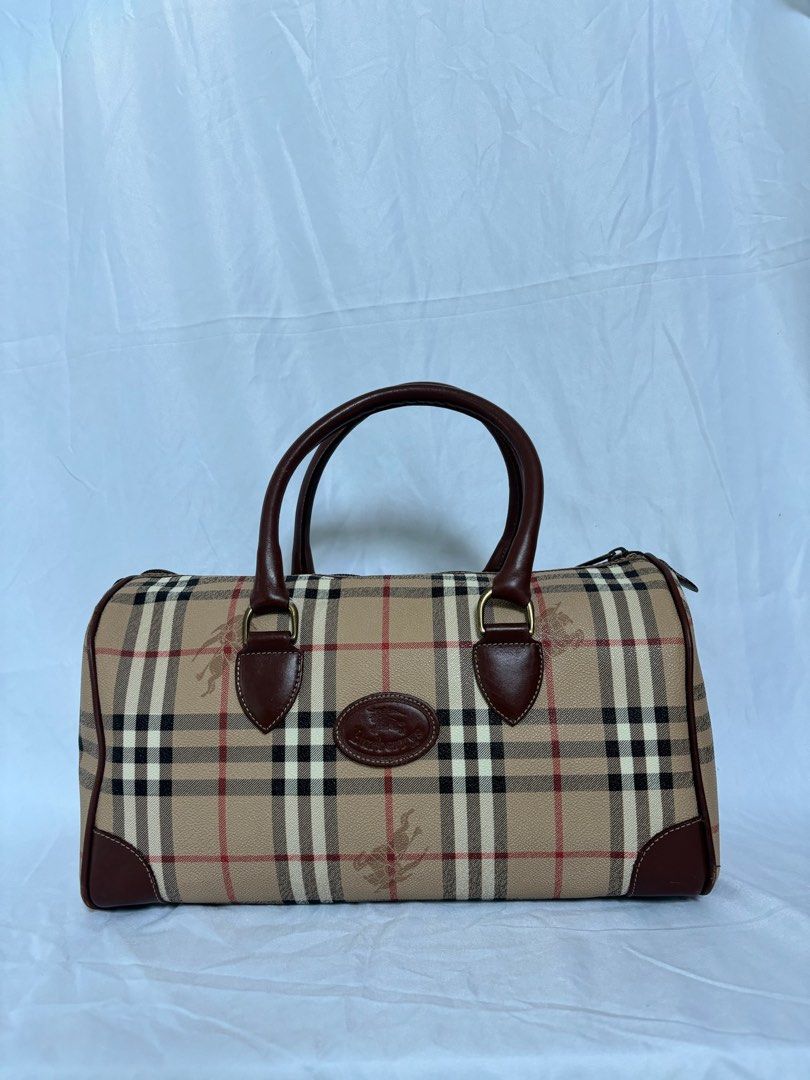 Vintage Burberry Nova Check Boston Bag (Category: Luxury Bags & Wallets) located in Manila. Submitted by prelovedby.gigi (Listing ID 1446253141, Image 1). Description: Vintage Burberry Nova Check Boston Bag original / authentic condition: • fair condition • minimal scratches (leather) • flaking (interior) details: • style: boston bag • material: pvc leather • 1 zipper pocket inside (ykk zipper) • size: W13.4” x H7.5” x D7.1” price is negotiable. 