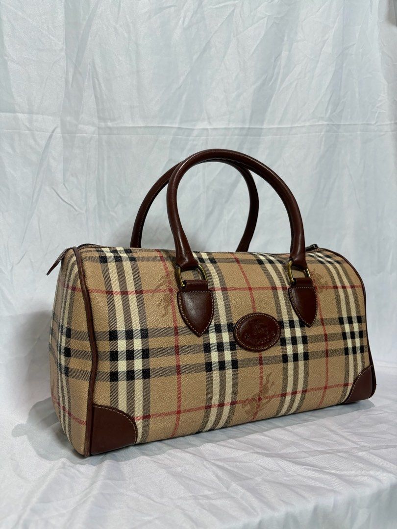 Vintage Burberry Nova Check Boston Bag (Category: Luxury Bags & Wallets) located in Manila. Submitted by prelovedby.gigi (Listing ID 1446253141, Image 2). Description: Vintage Burberry Nova Check Boston Bag original / authentic condition: • fair condition • minimal scratches (leather) • flaking (interior) details: • style: boston bag • material: pvc leather • 1 zipper pocket inside (ykk zipper) • size: W13.4” x H7.5” x D7.1” price is negotiable. 